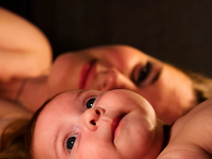 shallow focus photography of baby beside woman